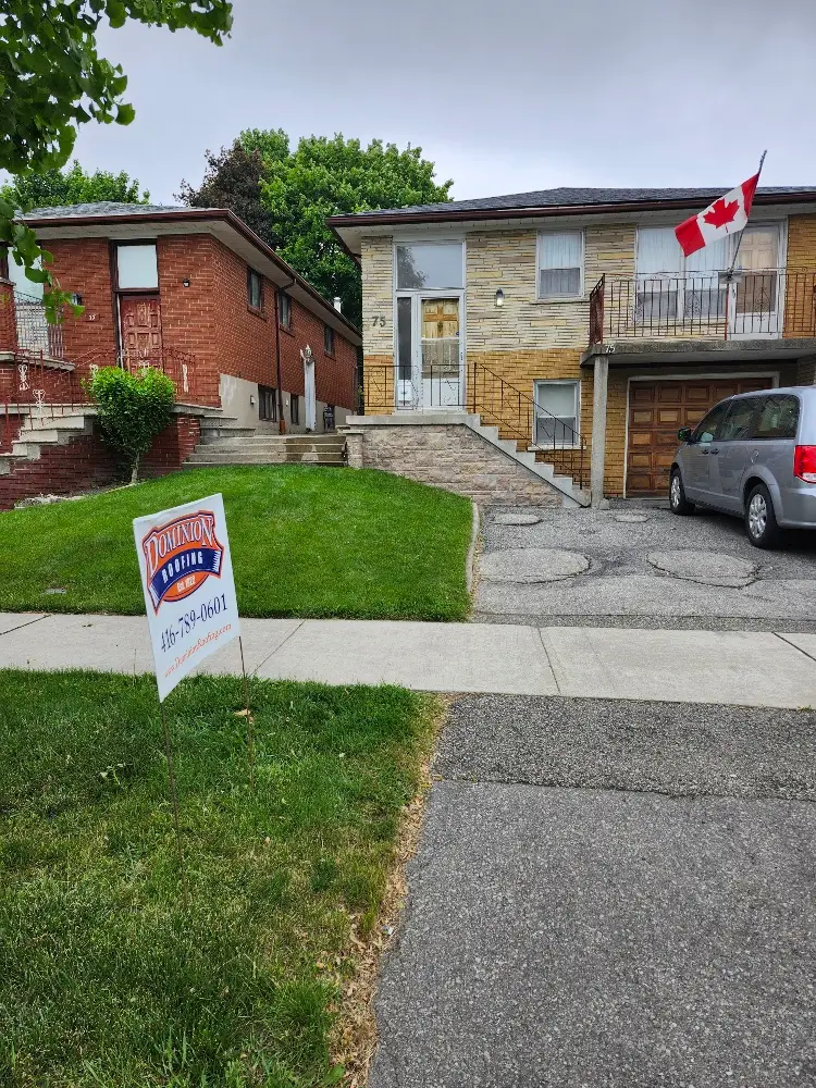 A house with a Canadian flag on the balcony, a car parked in the driveway, and a “Dominion Lending Centres” sign with a phone number on the lawn. The sky is overcast and there are trees and another house nearby. Dominion Roofing | BRAMPTON | BURLINGTON | ETOBICOKE | MARKHAM | MISSISSAUGA | NORTH YORK | OAKVILLE | RICHMOND HILL | Scarborough | TORONTO | VAUGHAN | dominionroofing.com | Phone Number: 416-789-0601