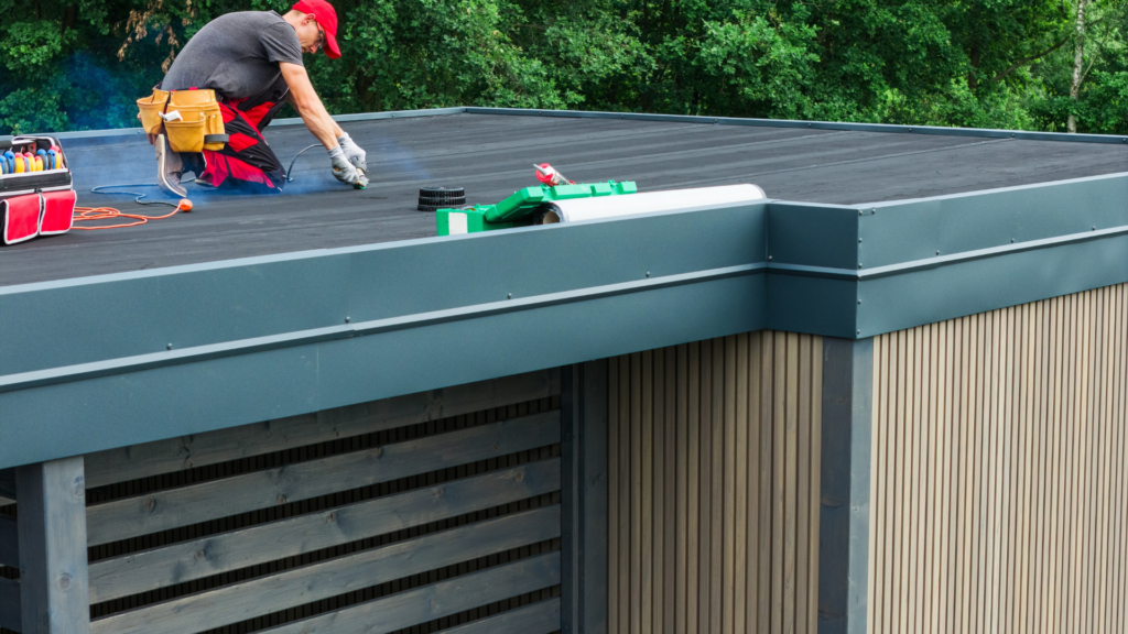 Roofing technician completing a flat roof repair on a Toronto low-slope roof