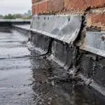 Why Is My Flat Roof Leaking Where It Meets a Wall?