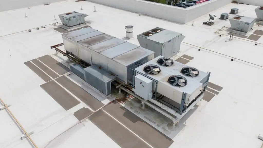 Commercial roof leaks around HVAC units caused by damaged rooftop equipment curb flashing and surrounding roofing membranes