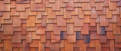 Close-up of a wooden shingle wall, showcasing Specialty Commercial Roofing Solutions. The pattern of overlapping rectangular shingles in warm brown tones creates a textured surface with varying shades due to light and wood grain variations. Dominion Roofing | BRAMPTON | BURLINGTON | ETOBICOKE | MARKHAM | MISSISSAUGA | NORTH YORK | OAKVILLE | RICHMOND HILL | Scarborough | TORONTO | VAUGHAN | dominionroofing.com | Phone Number: 416-789-0601
